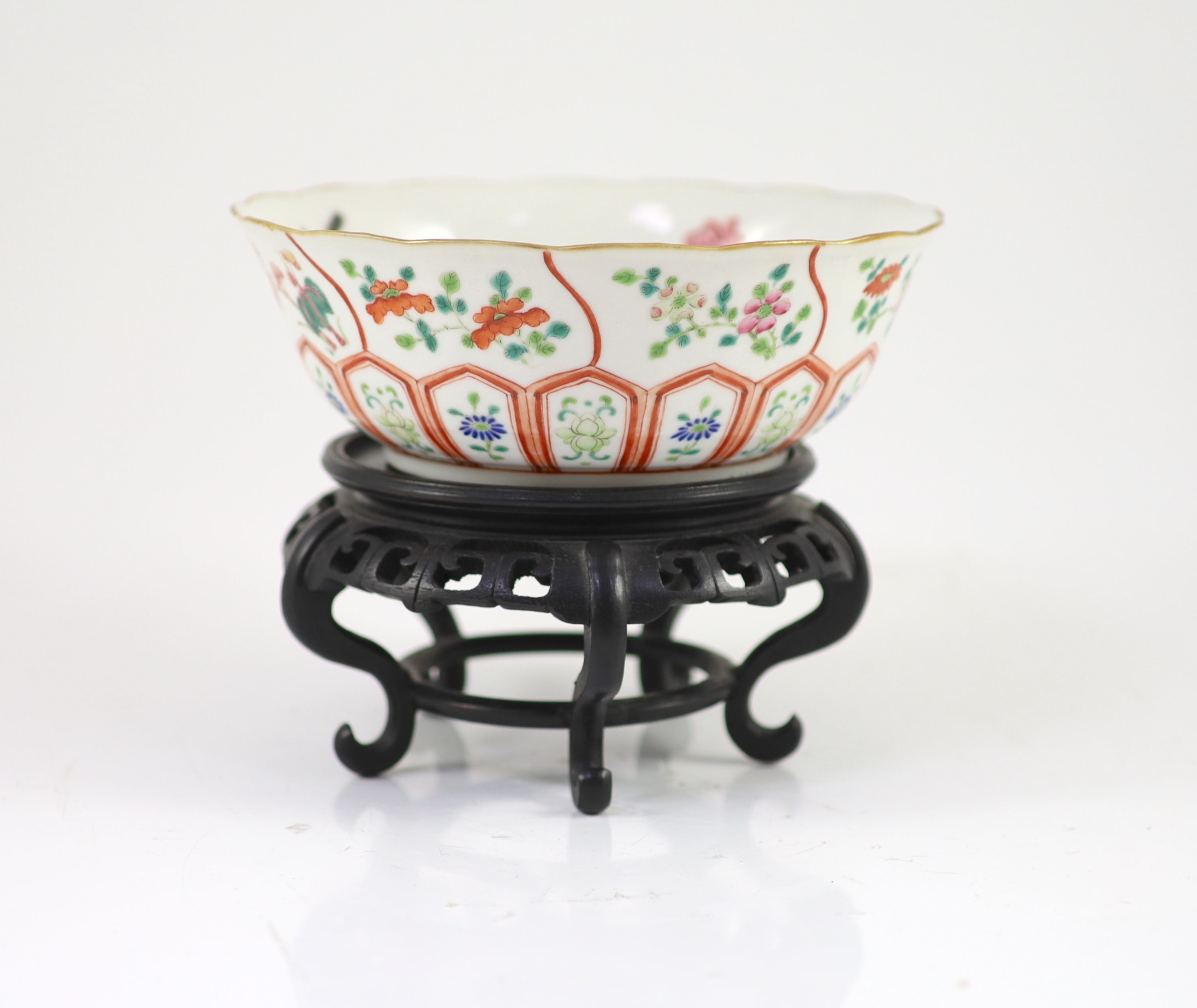 A Chinese famille rose bowl, Daoguang seal mark and of the period (1821-50), 17.8cm diameter, wood stand
